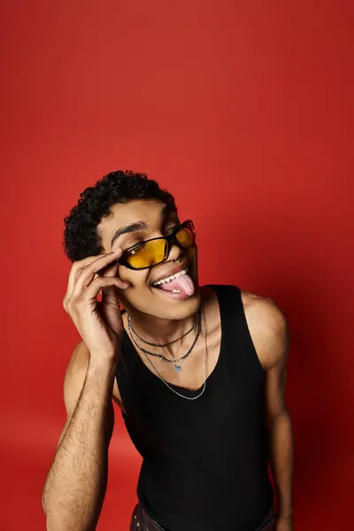 stock image Handsome African American man with sunglasses, sticking out his tongue playfully.