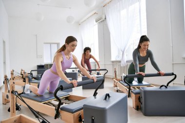 Group of women engaged in intense workout in gym setting. clipart