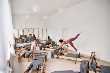 Çekici kadınlar spor salonunda pilates yapar..
