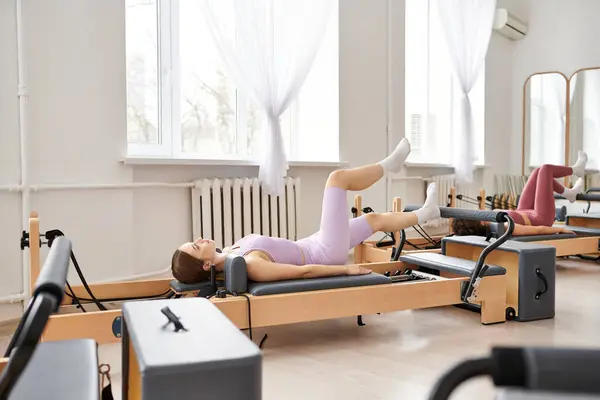 stock image Pretty women engaging in a pilates workout at the gym.