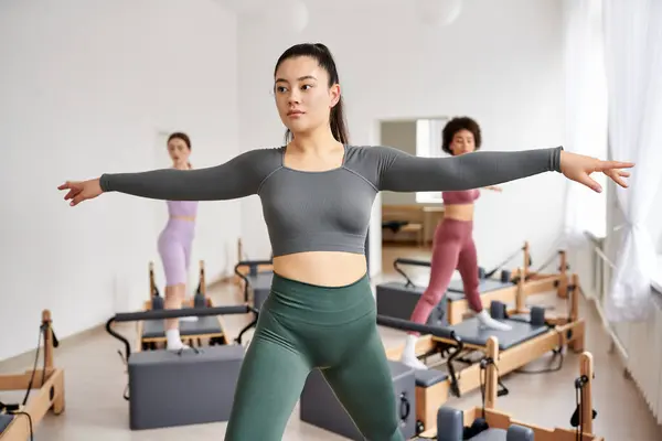 Stock image Sporty women engaging in a dynamic Pilates class.