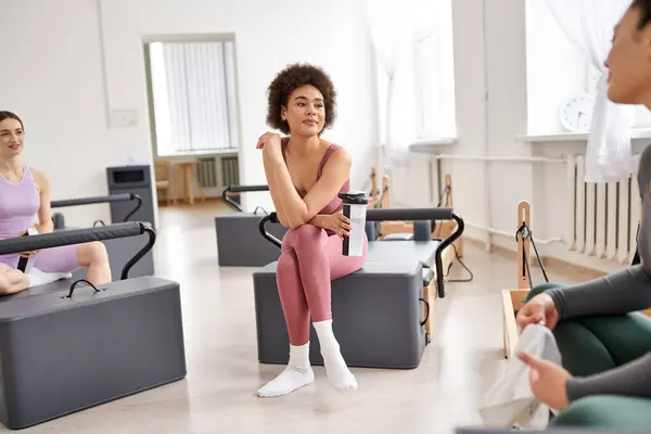 Stock image Alluring women spending time together on pilates lesson in gym, relaxing.