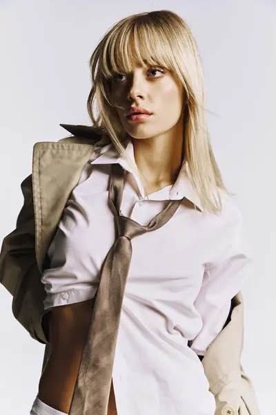 stock image Stylish woman exudes confidence in white shirt and tie, posing for a portrait.