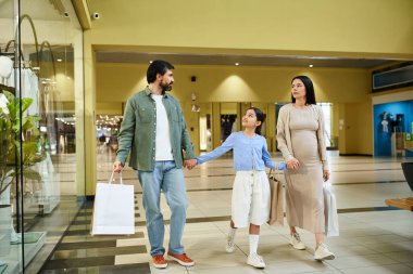 A joyful family strolling through a bustling mall, carrying colorful shopping bags filled with their weekend finds. clipart