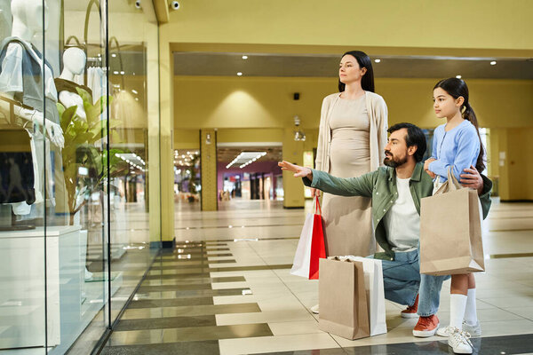 A happy family examines their shopping bags in a busy mall during a fun-filled weekend outing.