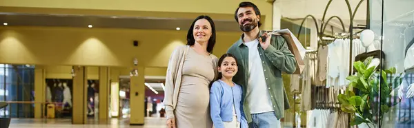 stock image A cheerful family enjoys a shopping weekend, bonding as they walk together through a busy shopping mall.