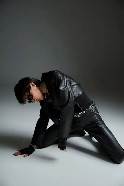 stock image Stylish woman in leather jacket posing on the floor