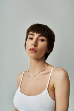 Stylish woman in white top strikes a pose for the lens.