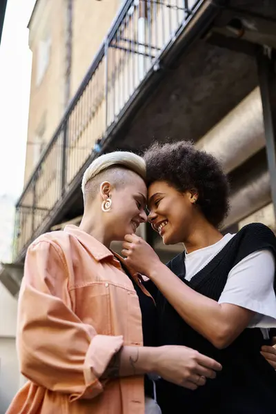 stock image Diverse lesbian couple standing together in a cafe.