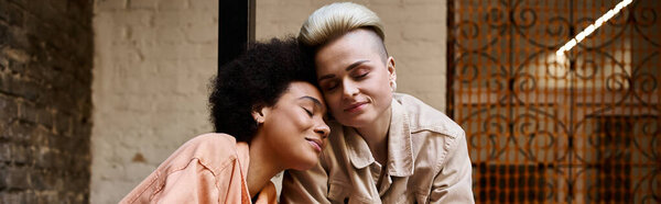 Two women sitting closely together, engaged in conversation.