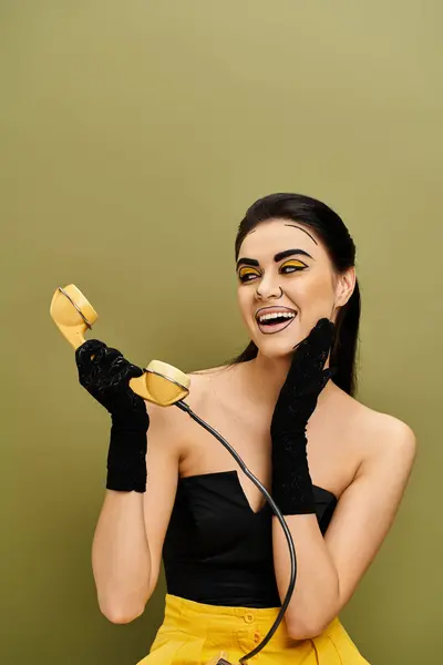 stock image A fashionable brunette woman with retro phone