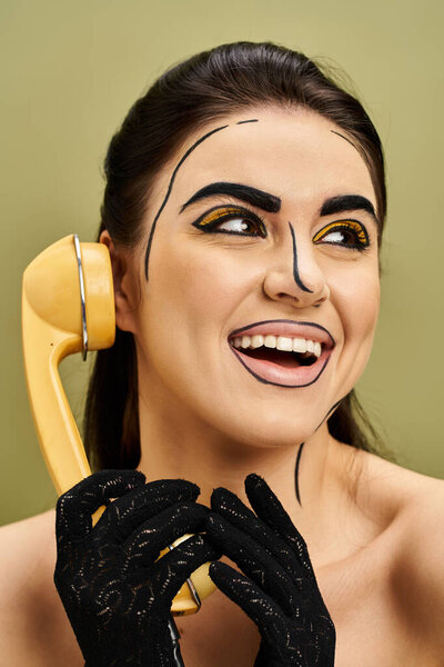 Stylish brunette in pop art makeup, holding phone to her face, embodying modern communication and beauty.
