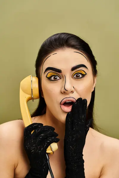 stock image Brunette woman in pop art makeup and black gloves holds phone to face.