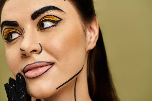 Brunette woman in striking black and yellow face paint, embodying vibrant pop art style