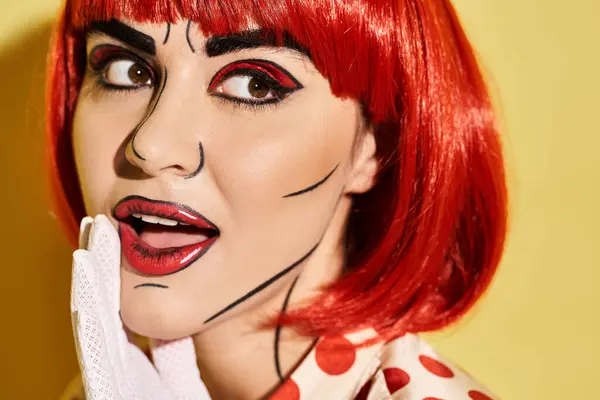 stock image Close-up view of a pretty redhead woman with creative pop art makeup and polka dot blouse on a yellow background.