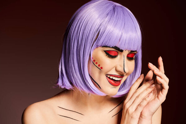 A beautiful woman wears a vivid purple wig and bold, comic-inspired pop art makeup on a black background.