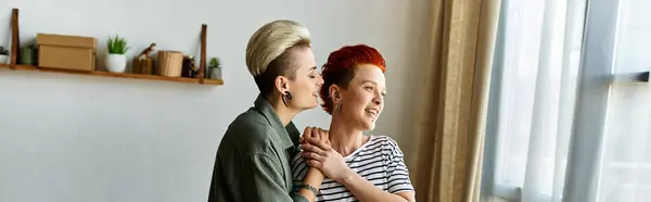 stock image A young lesbian couple, standing side by side, working together for a charity cause.