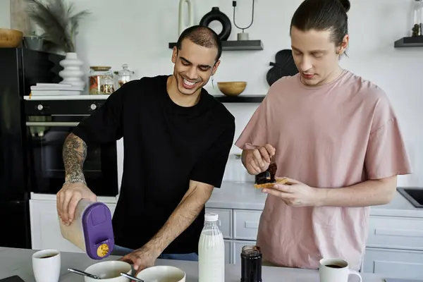 stock image A young gay couple enjoys a relaxed morning routine in their modern kitchen, preparing breakfast together.