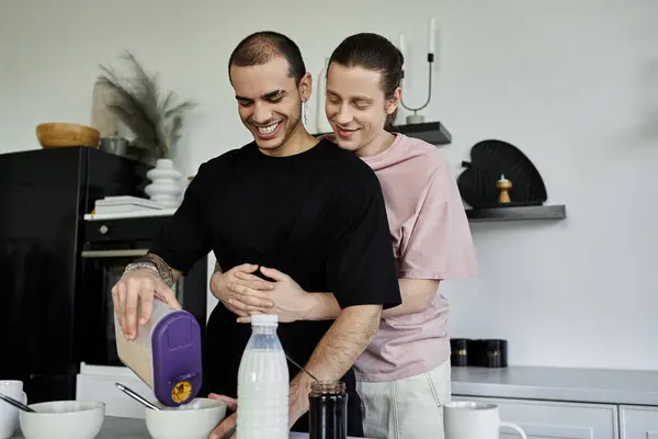 stock image A young gay couple makes breakfast together in their modern kitchen.