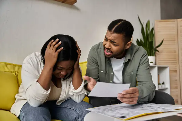 stock image A young African American couple at home in a difficult financial situation.