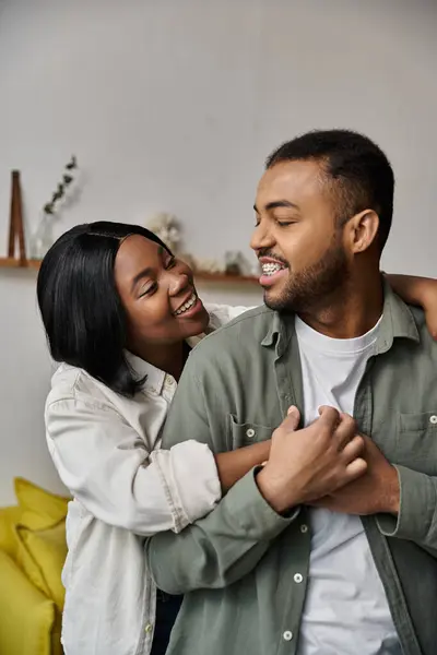 stock image A loving African American couple embraces at home.