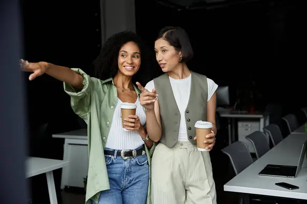 stock image Two women, colleagues and partners, take a coffee break in the office.