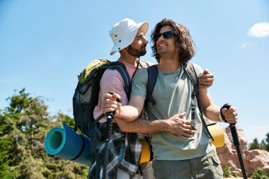 A young gay couple enjoys a summer hiking trip, sharing a loving embrace amidst beautiful natural scenery. clipart