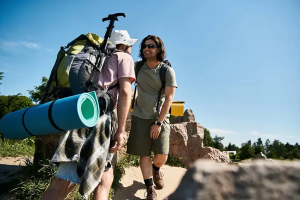 Stock image A young gay couple hikes through the wilderness on a sunny summer day.