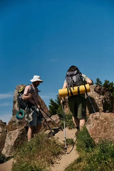 stock image A young gay couple hikes through a scenic wilderness area on a sunny summer day.