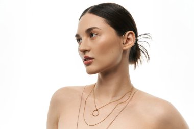 A young brunette woman shows off her elegant jewelry against a white background, showcasing beauty and fashion. clipart