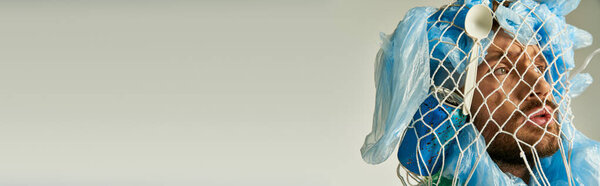 A man's face is obscured by plastic bags and a net.