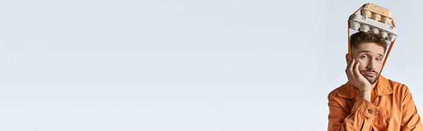 A man in an orange jumpsuit stares blankly ahead, trapped in a plastic prison of his own making.