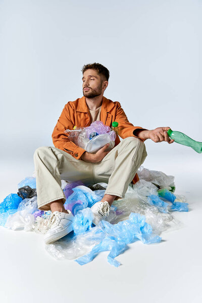 A man sits surrounded by plastic waste, a silent commentary on modern consumerism.