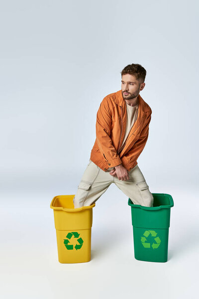 A man stands in two recycling bins.