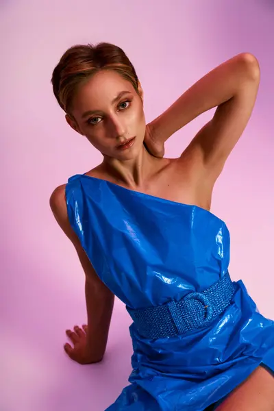 stock image A beautiful woman in a sustainable fashion blue dress posing gracefully.