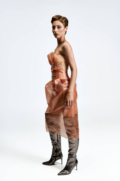 A woman in a sustainable fashion dress made of plastic.