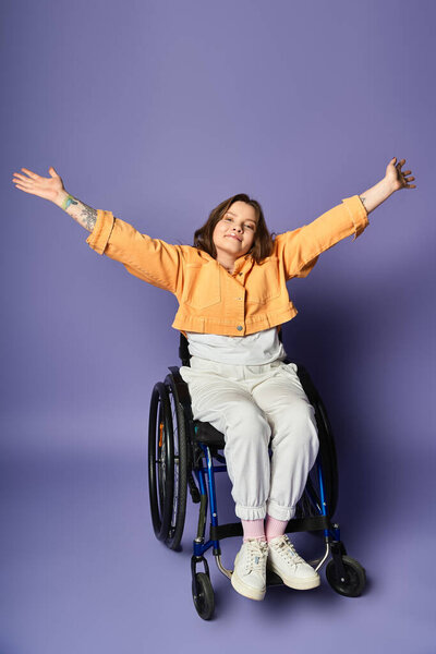 A young woman in a wheelchair sits against a purple background, with her arms raised in a gesture of joy and freedom.