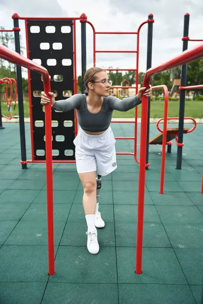 stock image A young woman in sportswear is actively working out while enjoying the outdoors.