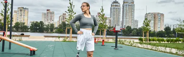 stock image A young woman exercises outdoors, showcasing her strength and determination in sportswear