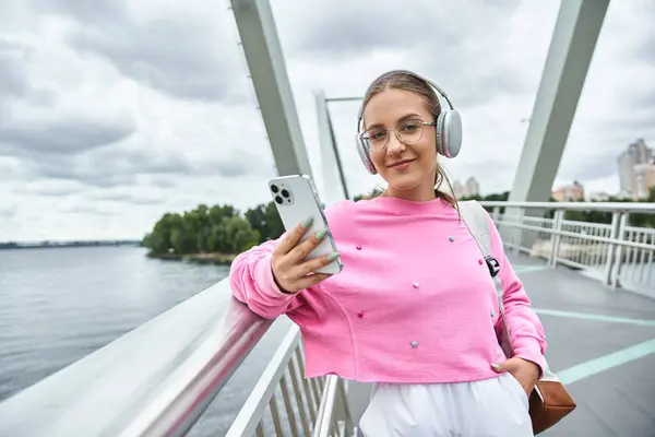 stock image A young woman smiling and listening music in her headphones