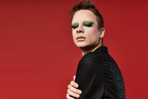 A stylish young performer showcases their vibrant look with confident flair.