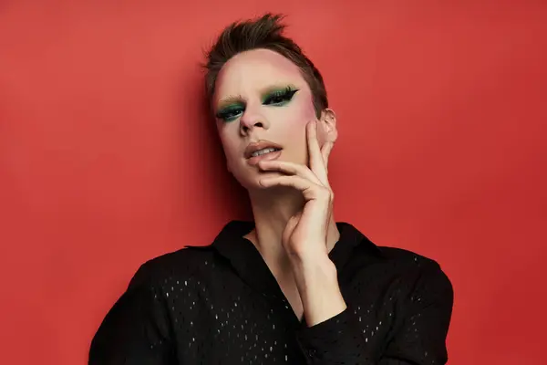 stock image A young drag artist exudes confidence and flair in striking attire and vivid makeup.