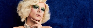 Canlı bir travesti muhteşem giysiler ve çarpıcı makyajlar sergiler..