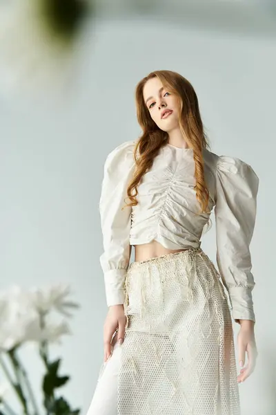 stock image A young woman stands beautifully adorned with flowers, exuding elegance and charm.