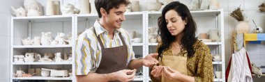 A couple joyfully collaborates on pottery in a bright, contemporary workspace. clipart