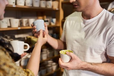 A couple joyfully creates unique pottery pieces side by side. clipart