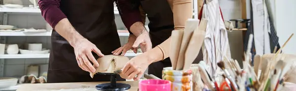 stock image A loving couple molds clay as they share a joyful pottery session.