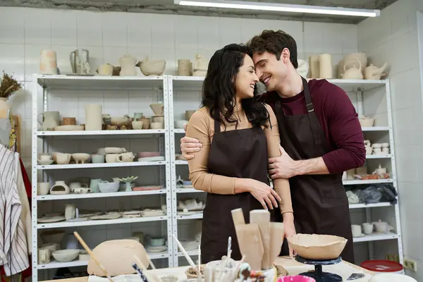 stock image A joyful couple shares a moment while shaping clay in an artistic space.