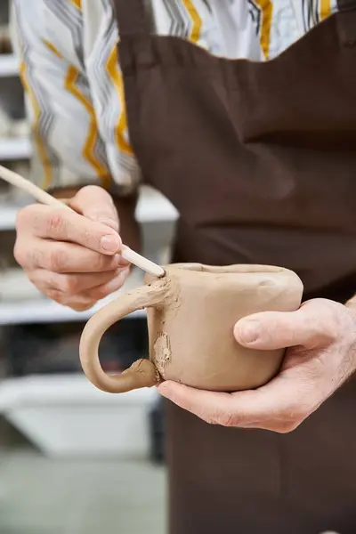 stock image Man making pottery in well lit studio.