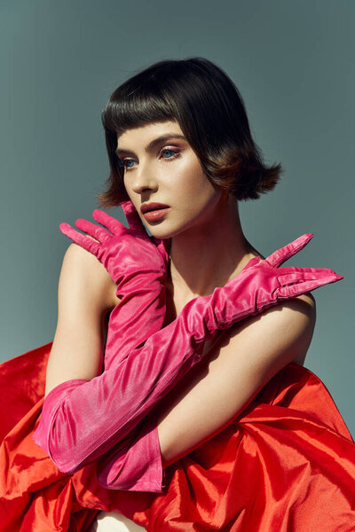 Стильная женщина демонстрирует свой смелый выбор моды с яркой позой и яркими цветами.